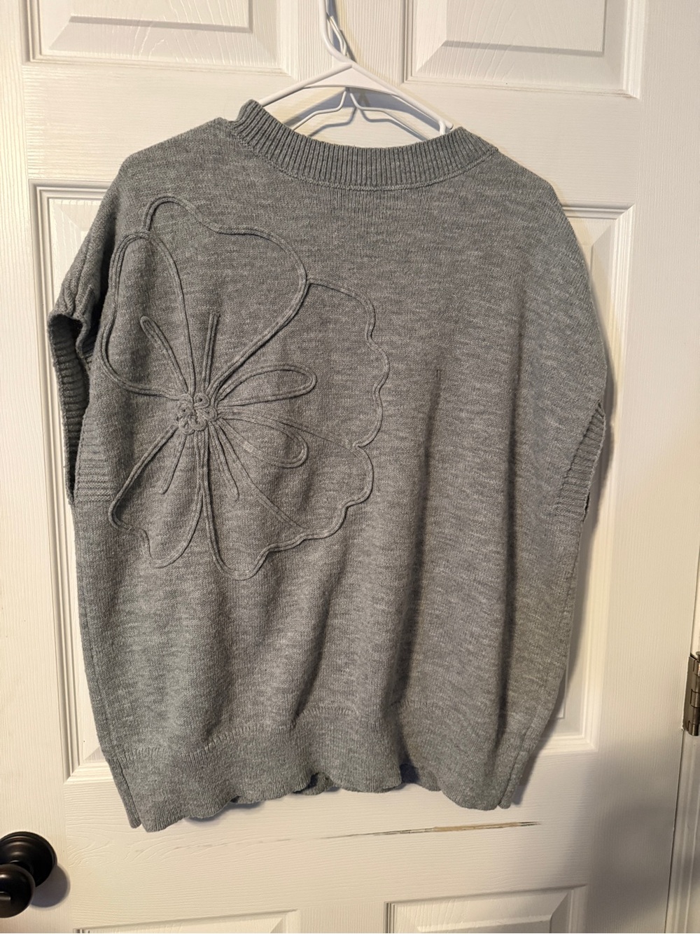 Grey sleeveless sweater with floral detail